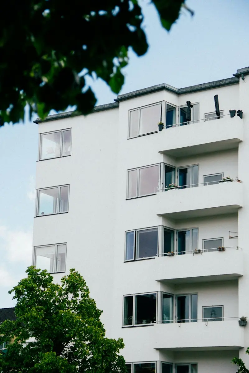 White apartment building with balconies on every floor