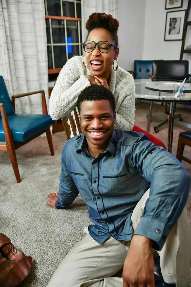 A smiling couple relaxing together in their living room